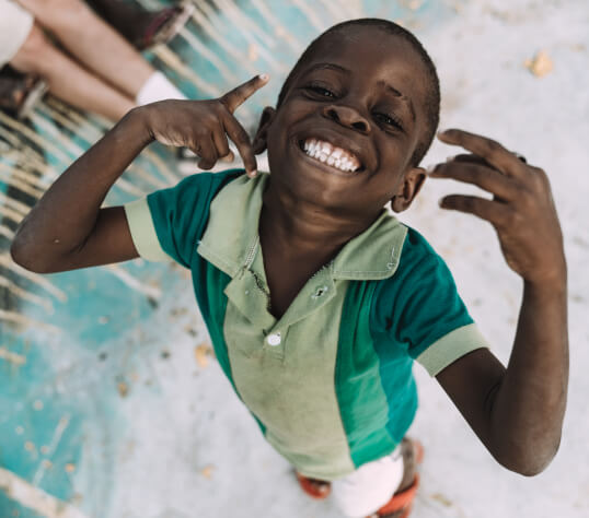 Angola kid smiling at the skatepark