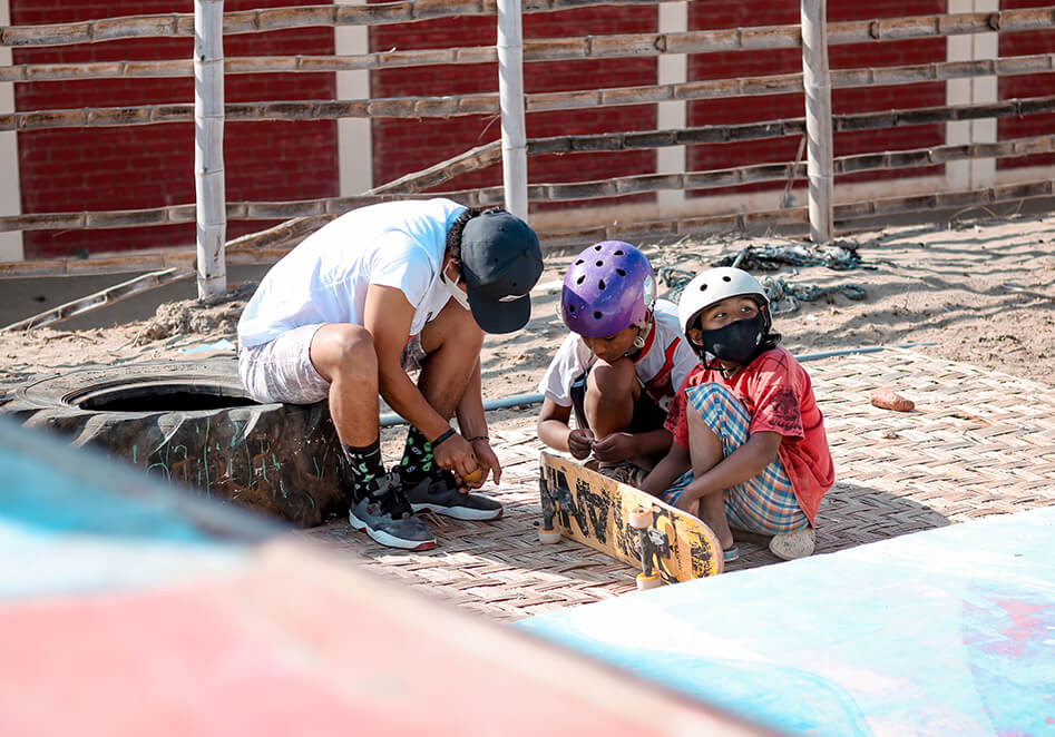 Emilio Rodriguez helping setting up a skateboard