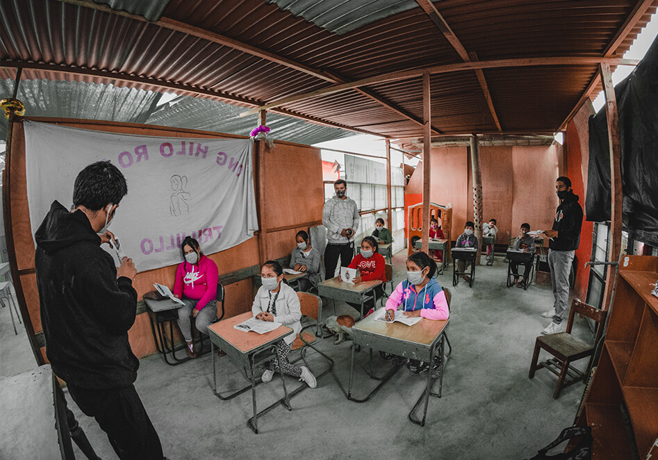 Emilio Rodriguez teaching skateboarding in a classroom in Peru
