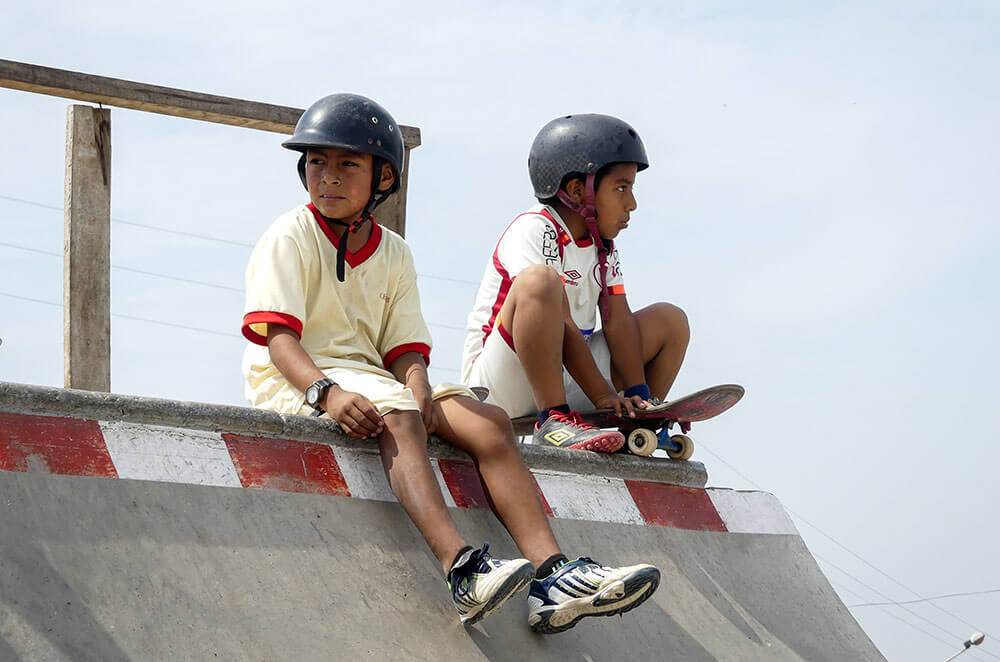 Two kids on a ramp at the Alto Trujillo Skatepark in Peru