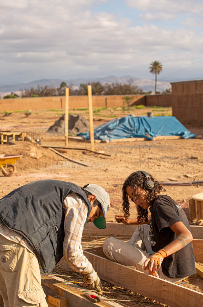 Simo and Aya working on a ledge during the Fiers et Forts Skatepark construction in Morocco