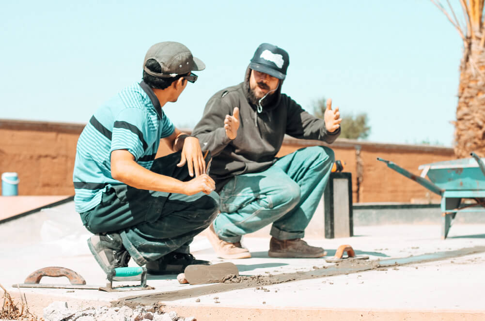 Teacher explaining the science of repairing concrete safely at Fiers et Forts Skatepark in Morocco